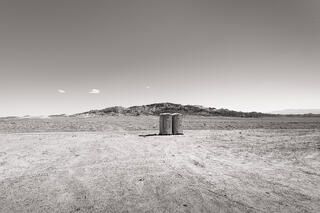 Two portapotties in a large parking area, Nevada