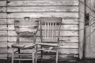 Two wooden chairs outside an abandoned house in Keeler, California
